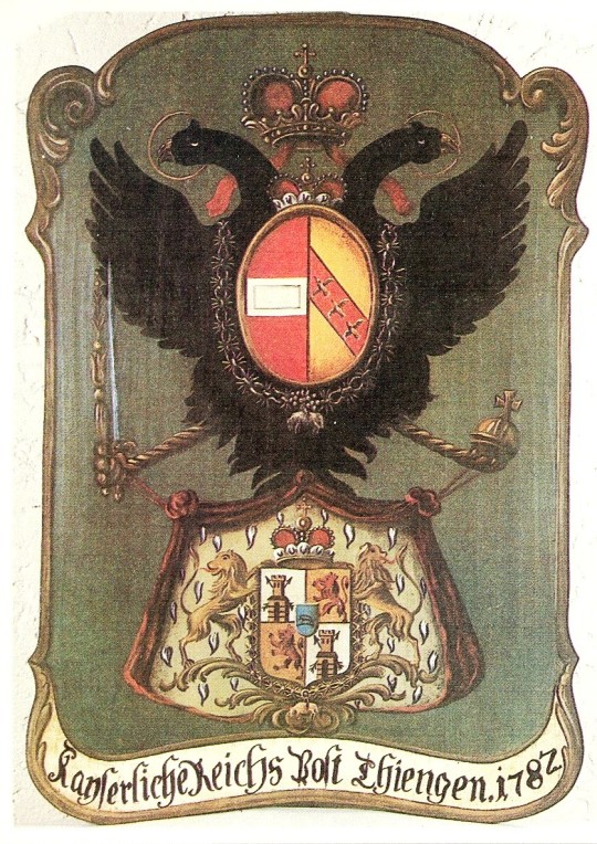 A postboard ( Posttafel ) from 1782, of the type displayed outside Austrian post offices under the old régime. The arms above are a simplified version of the Austrian imperial arms of the time; the arms below are those of the princely family of Thurn und Taxis , who held an imperial license to operate the post office as a monopoly. The legend means Imperial Government Post Thiengen 1782 . The cover was issued by the West German Post Office in 1979 as part of the annual “Europa” series marking the meetings of the European Conference of Postal and Telecommunications Administrations .